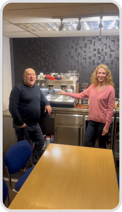A man and an woman near coffee machine