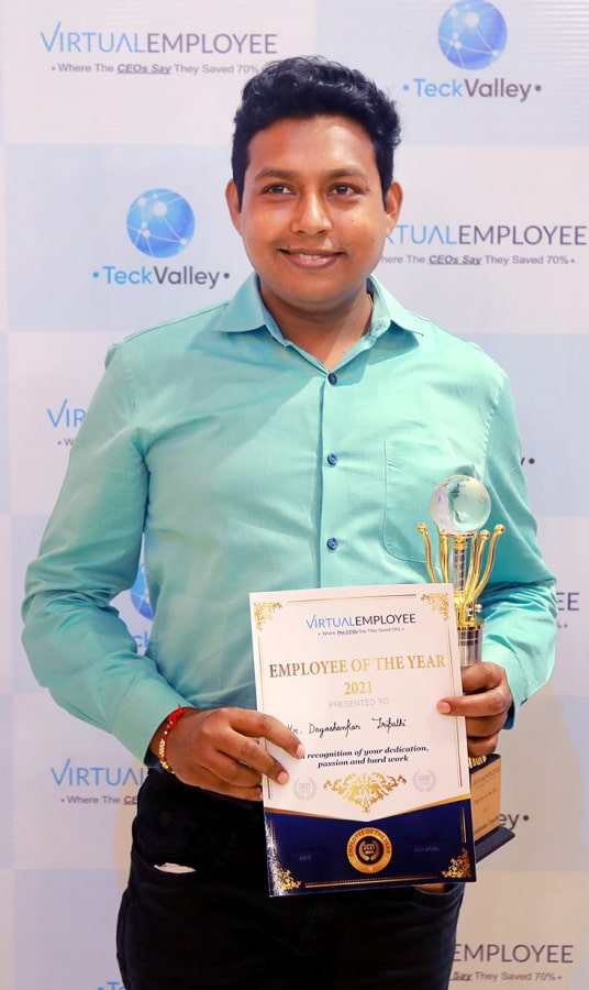 A Man holding Employee of the year award