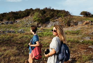 Two women standing on a grass field