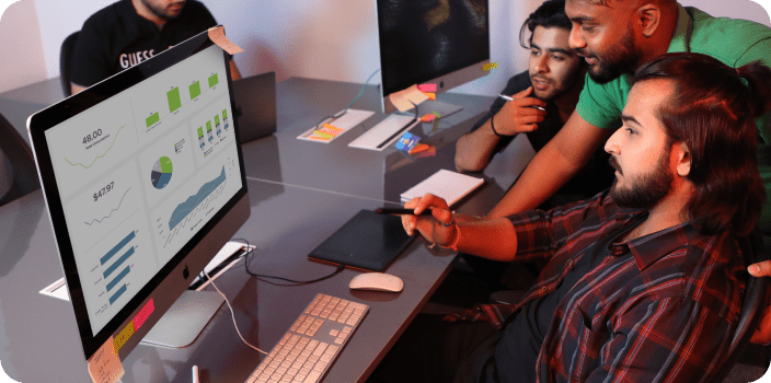 A Team member pointing on the laptop and discussing work